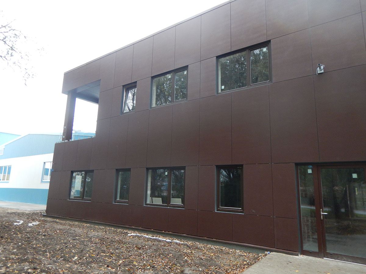 Dvojposchodová administratívna budova so sedlovou strechou má opláštenie vonkajších stien riešené cementotrieskovými doskami CETRIS® FINISH