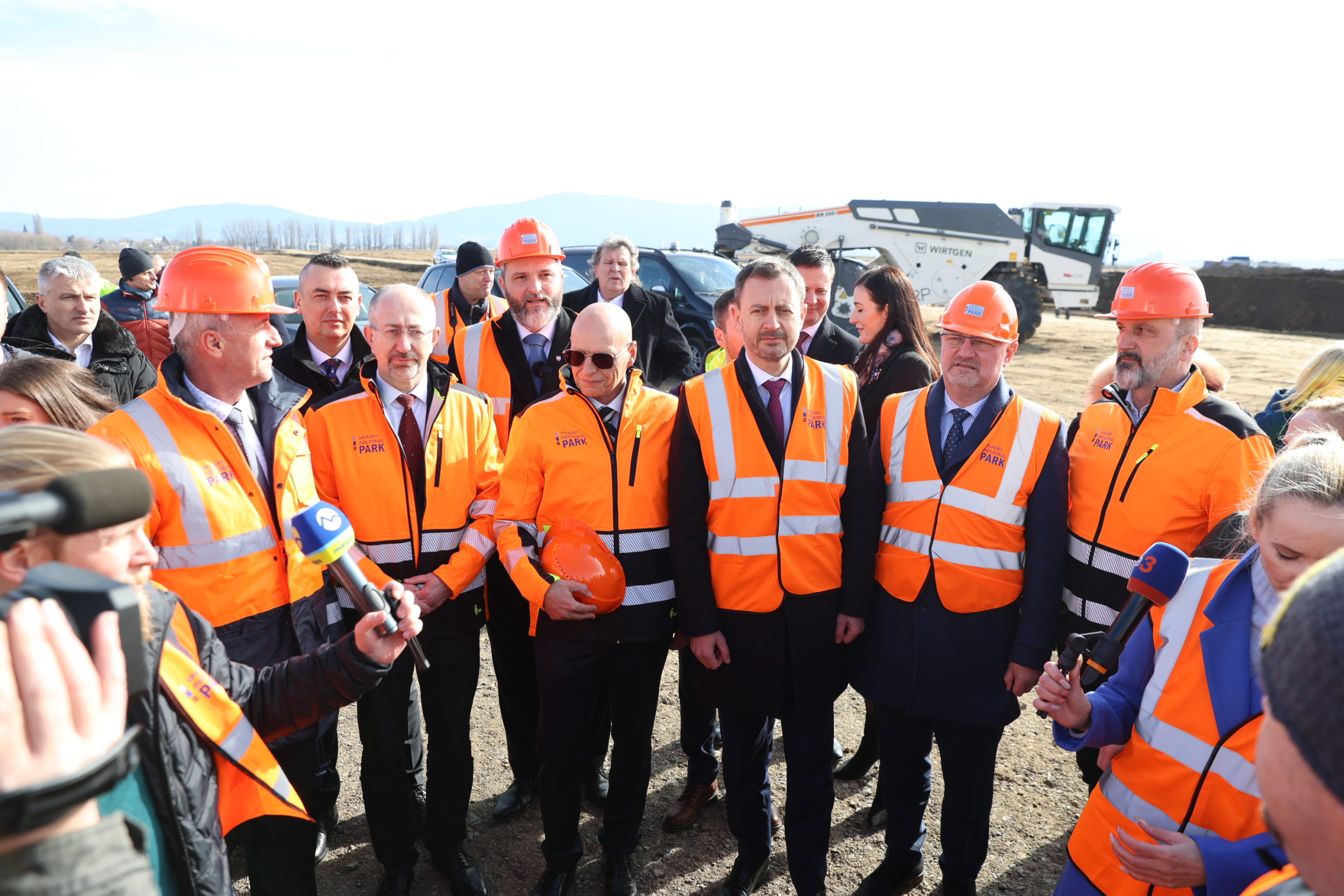 Dočasne poverený predseda vlády SR Eduard Heger (uprostred vpravo) a dočasne poverený minister hospodárstva SR Karel Hirman (v popredí druhý vľavo) počas slávnostného výkopu a začatia stavby budúceho priemyselného parku Valaliky.