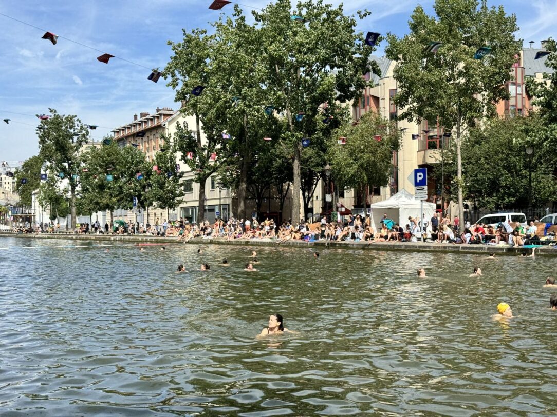 People swimming in the Canal Saint Martin on a summer day in Paris