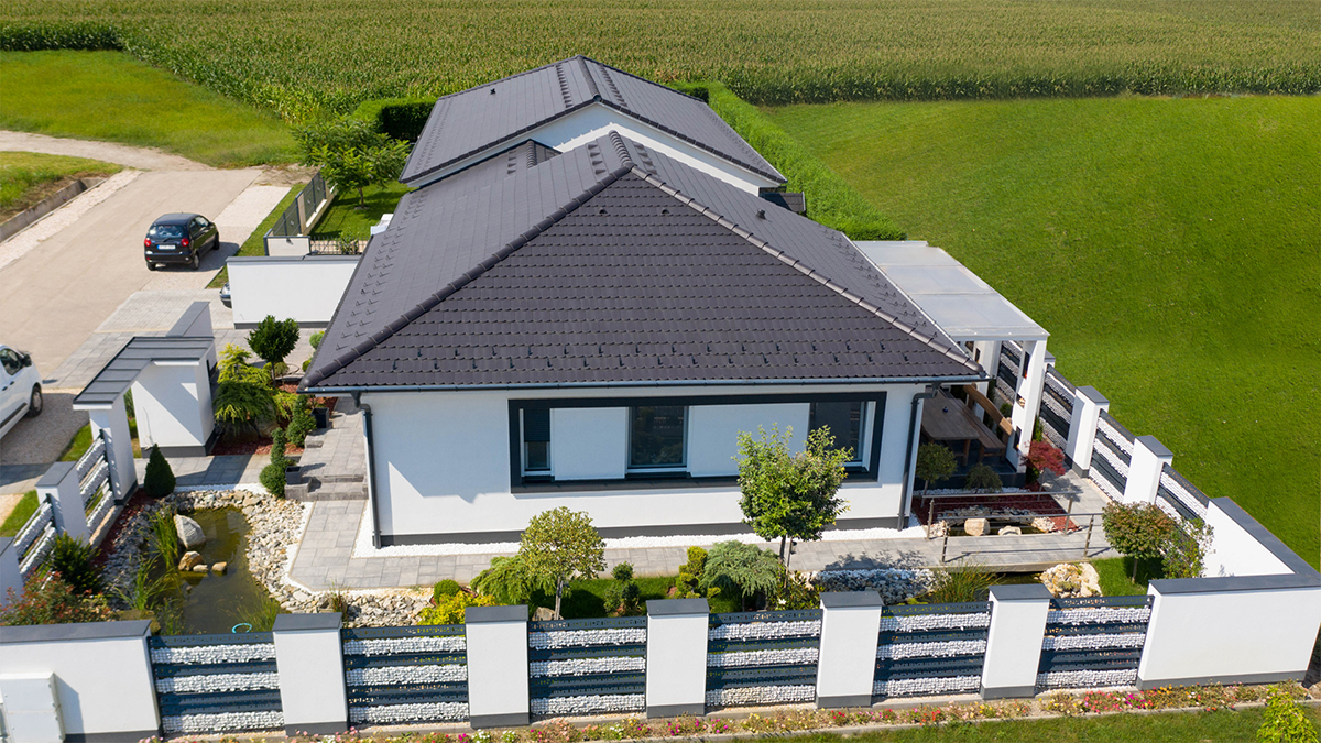 Moderný bungalov s tmavosivou betónovou strechou a minimalistickou architektúrou