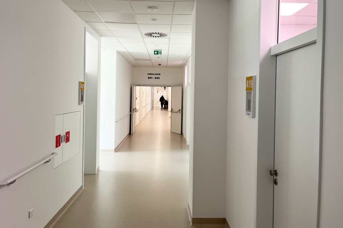 Nemocničná chodba s označením ambulancií a integrovanými technickými prvkami