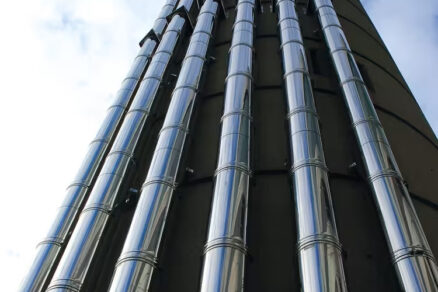 Viacprieduchový priemyselný komín z nehrdzavejúcej ocele na fasáde budovy