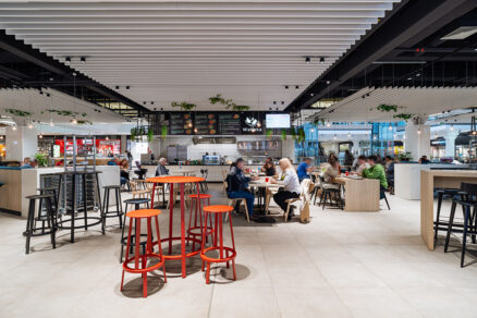 Foodcourt s moderným sedením, osvetlením a technickými prvkami v interiéri